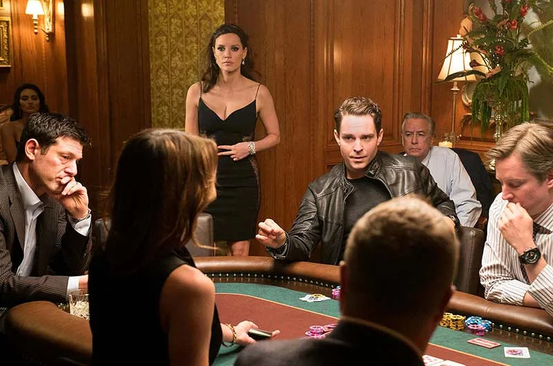 Cena do filme “A Grande Jogada” (2017) — Molly Bloom (Jessica Chastain) observa uma partida em seu clube de pôquer clandestino.